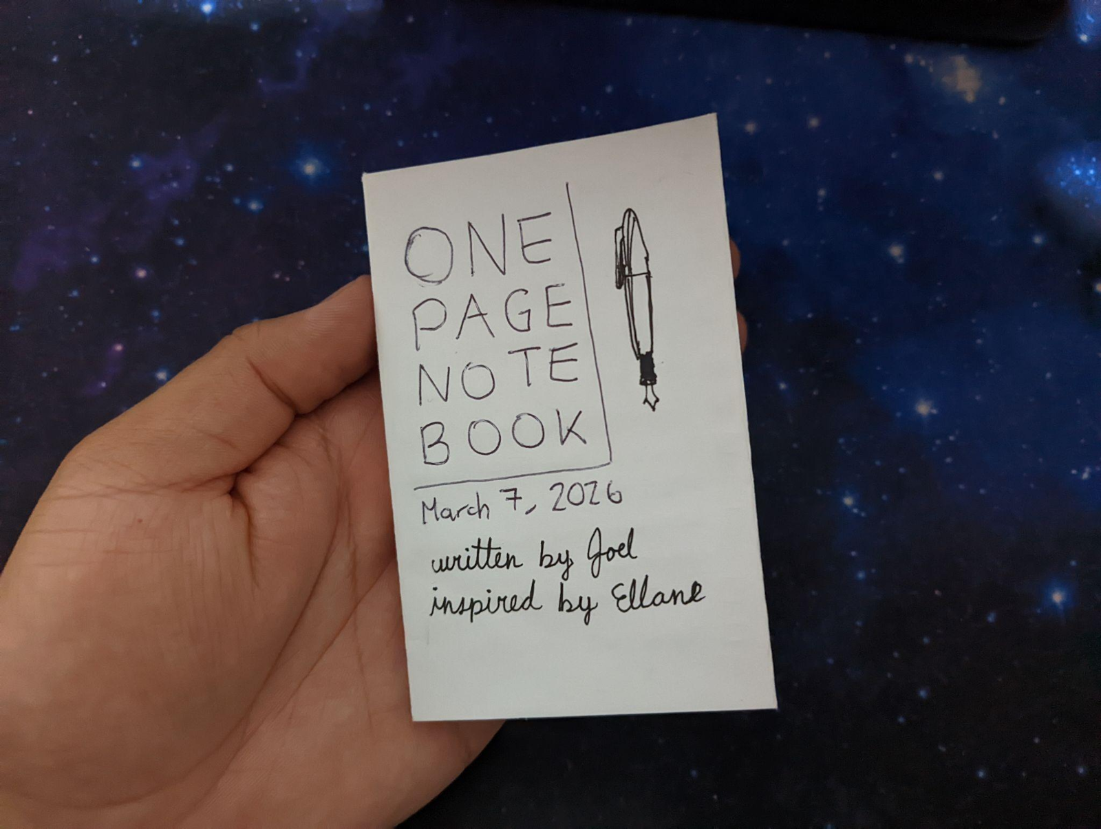 My one-page notebook closed and in my hand